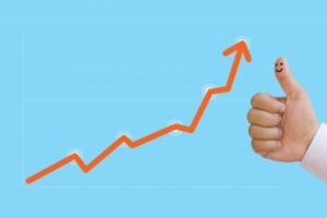 A thumbs up next to a graph showing the steady growth of an investment.
